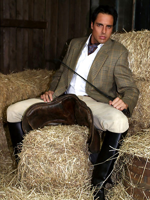 Free gay porn pics with Marcello dressed in full riding suit masturbating in the stables