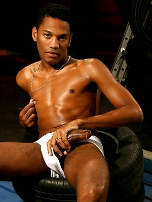 Gay male in Sexy english lad strokes his black cock